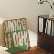 Room interior with a framed poster reading 'Dance It Out' on a wall.