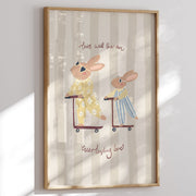 Framed artwork with two bunnies on scooters and text 'This will  be an everlasting love' on a striped background