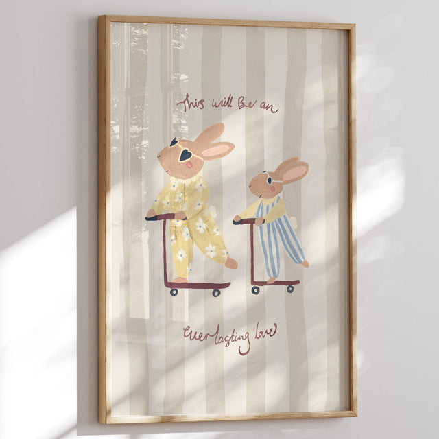 Framed artwork with two bunnies on scooters and text 'This will  be an everlasting love' on a striped background