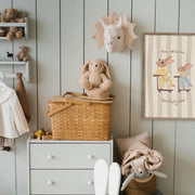 Children's room with a dresser, chair, and toys against a wooden paneled wall.