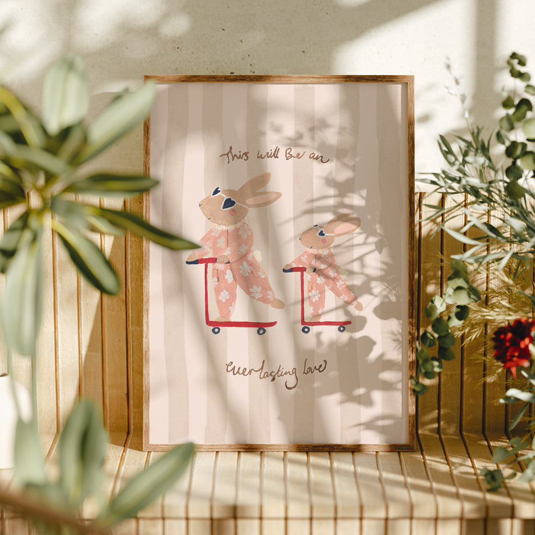Framed artwork with two rabbits on scooters in a natural setting with plants.