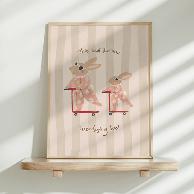 Framed artwork with cartoon bunnies on scooters and text on a striped background