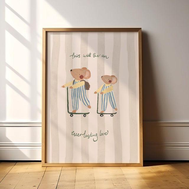 Framed artwork with two mice riding scooters on a striped background, and the words 'This will be an everlasting love'. Placed on a wooden floor.