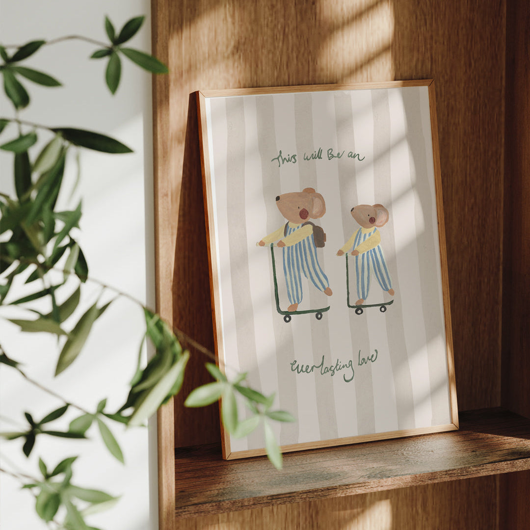 Framed illustration of two mice on scooters with text 'This will be an everlasting love', placed on a wooden shelf.