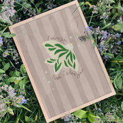Art print with green dove design and 'I adore you' text on a grassy background
