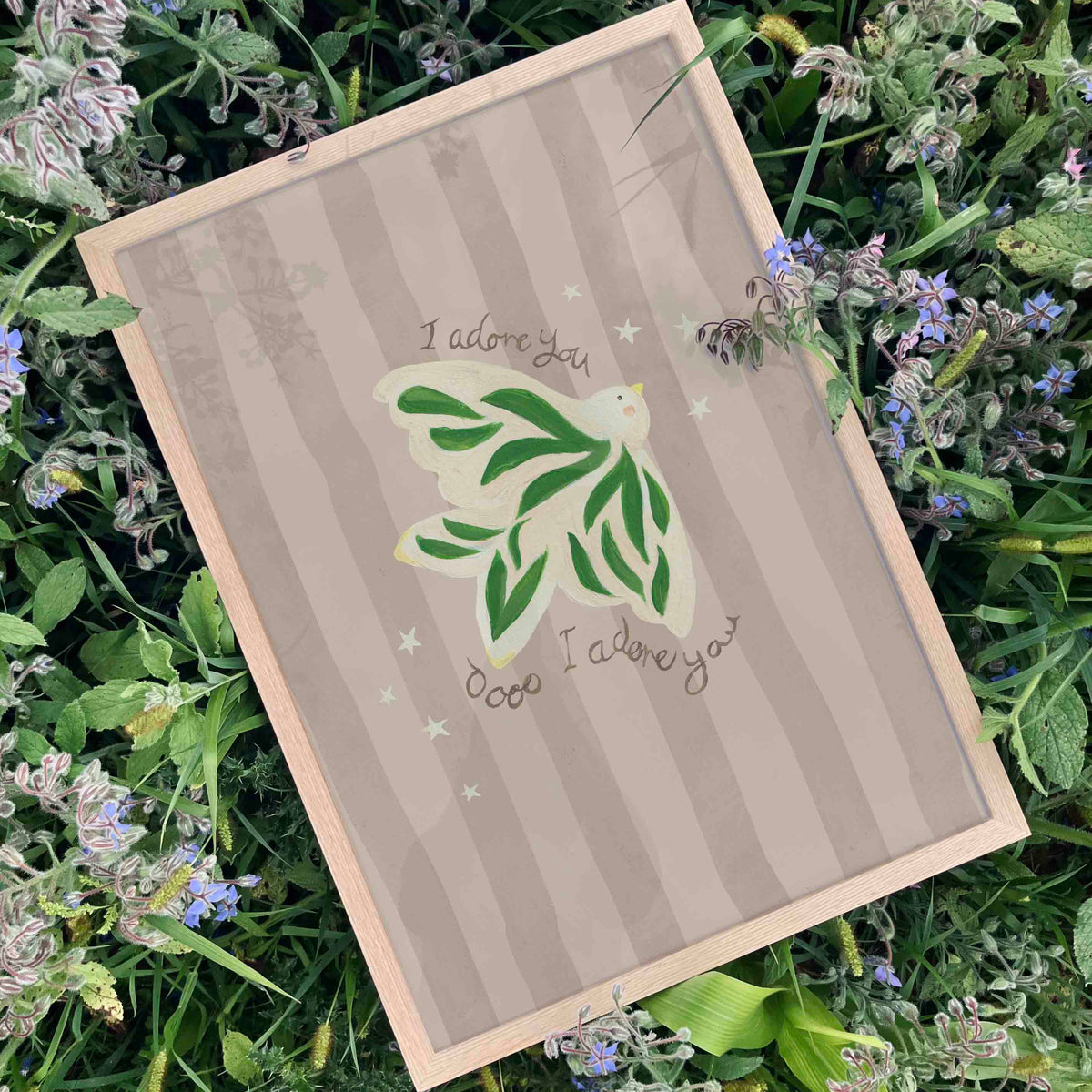 Art print with green dove design and 'I adore you' text on a grassy background