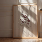 Framed artwork with a dove design and the words 'I adore you' on a wall with sunlight casting shadows.