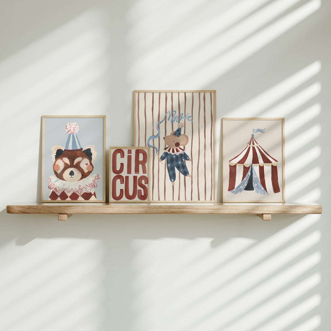 Four circus themed framed prints on a wooden shelf with sunlight casting shadows on a white wall.