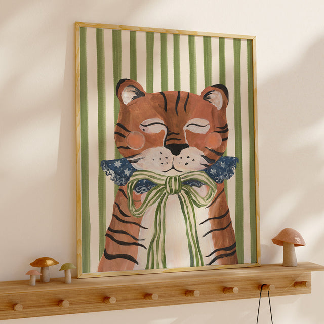Framed artwork of a tiger with a bow tie on a wall above a wooden shelf.