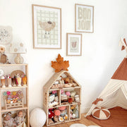 Children's playroom with toys, shelves, and wall art in a cozy setting.