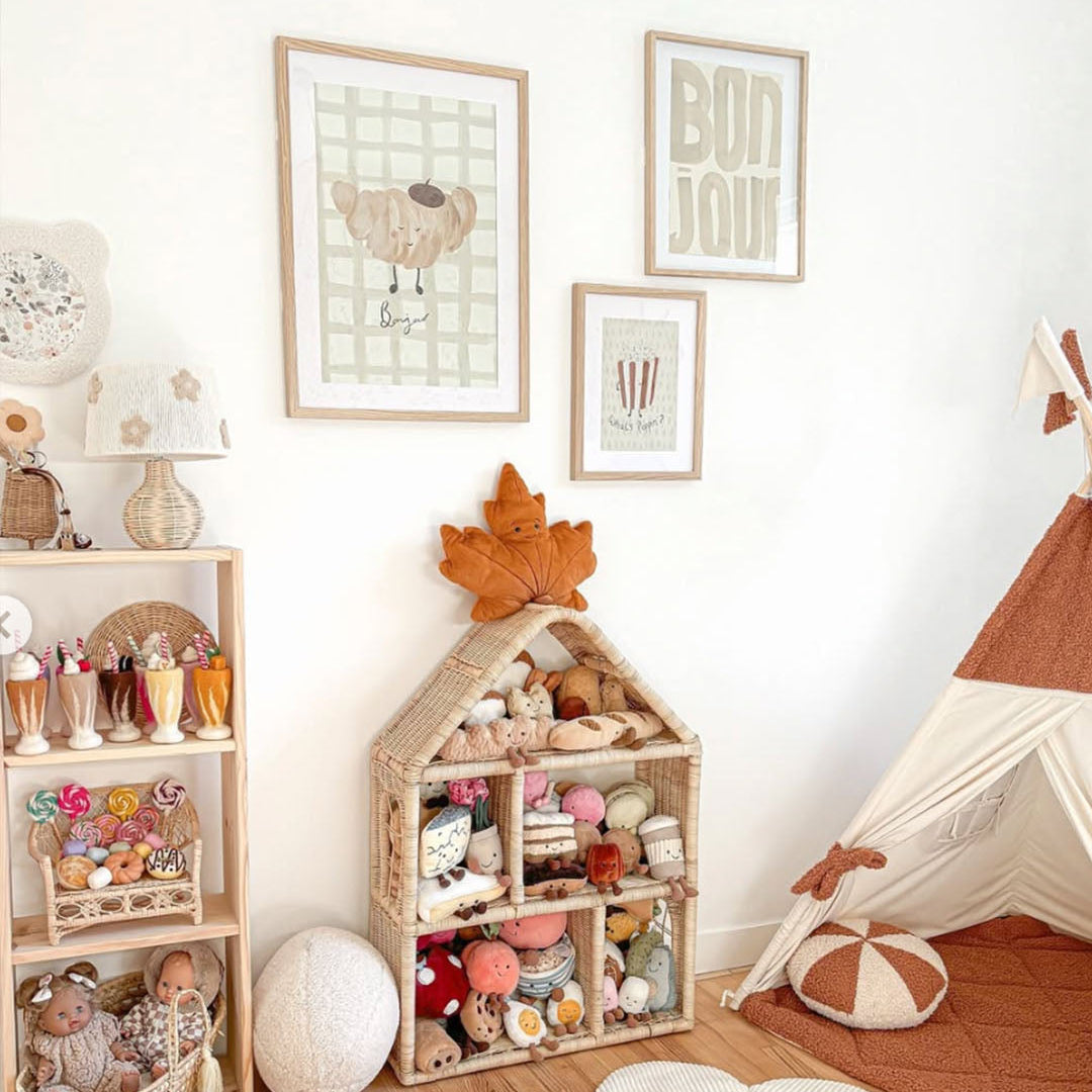 Children's playroom with toys, shelves, and wall art in a cozy setting.