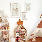 Children's playroom with toys, shelves, and wall art in a cozy setting.