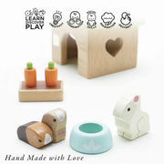 Le Toy Van Bunny & Guinea Pig Set including two wooden guinea pigs and a bunny rabbit complete with hutch, feeding bowl, and carrots for meals and nibbles. 