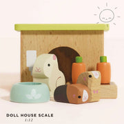 Le Toy Van Bunny & Guinea Pig Set featuring two wooden guinea pigs, a bunny rabbit, a hutch, a feeding bowl, and toy carrots, designed to trigger imaginative play and perfect for dollhouses, made from sustainably-sourced wood with non-toxic paints. 