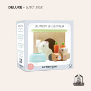 Le Toy Van Bunny & Guinea Pig Set in gift box, featuring wooden animal figures, hutch, feeding bowl, and carrots, designed for imaginative play. 
