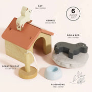 Le Toy Van Dolls House Pet Set featuring a wooden kennel, a plush pet bed, a dog and cat figure, a scratching post, and a pet bowl. 