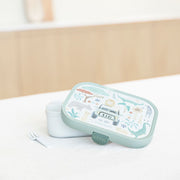 Little Dutch Safari Friends green bento lunch box with a lid decorated with cute safari animal illustrations, shown next to a small white utensil on a light surface.