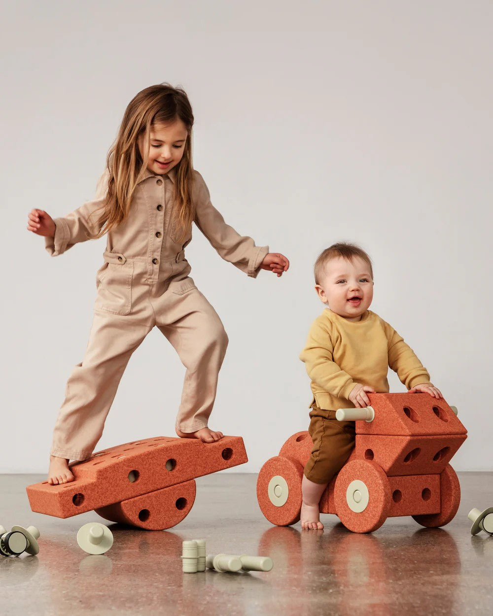 Two children playing with the MODU burnt orange Dreamer Set.