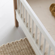 Close-up of an Oliver Furniture Wood Mini+ Junior Bed in white and oak, designed to provide a compact and safe sleeping space for young children. 