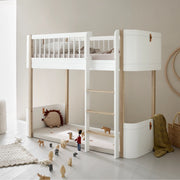 Oliver Furniture Wood Mini+ Low Loft Bed in white and natural oak with ladder, perfect for small rooms and featuring an open play space underneath for children ages 6 and up.