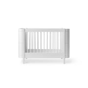 White Oliver Furniture Wood Mini+ convertible cot bed with junior kit that transforms from newborn cot to junior bed, suitable for children 0-9 years old.
