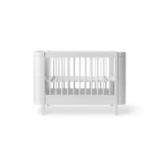 White Oliver Furniture Wood Mini+ convertible cot bed with junior kit, designed for children 0-9 years with adjustable mattress heights and removable bars.