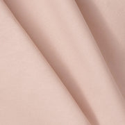 Close-up of soft pink, textured fabric with folds, perfect for Oliver Furniture Wood Original bunk bed or low loft bed curtain creating a cozy, imaginative space for kids. 