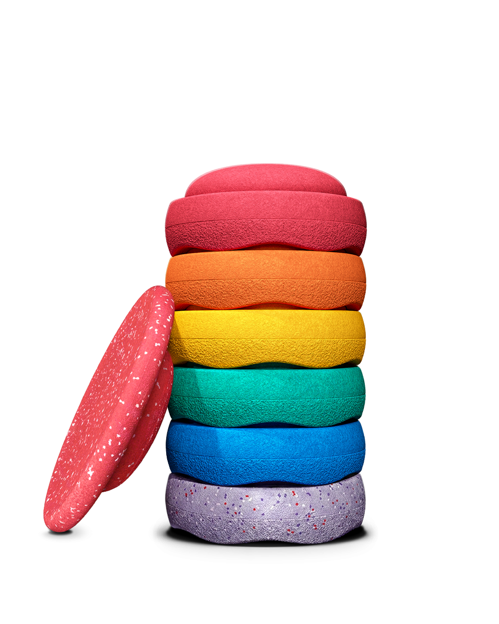 A stack of colourful stapelstein stepping stones in red, orange, yellow, green, blue, and purple, with one red wobble board.