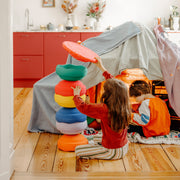 Two children playing in a cosy indoor play scene with Stapelstein Stepping Stones 6+1 Set Winter Special.