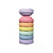 A stack of seven pastel mini stepping stones, pink, orange, yellow, mint, light blue, and violet, featuring confetti speckles.