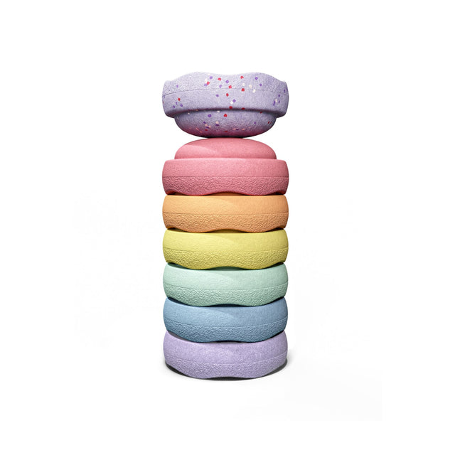 A stack of seven pastel mini stepping stones, pink, orange, yellow, mint, light blue, and violet, featuring confetti speckles.