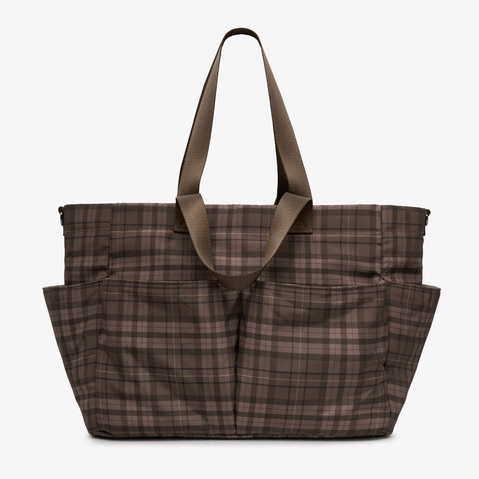 A brown and beige plaid tote bag with two shoulder straps, shown against a plain light gray background.