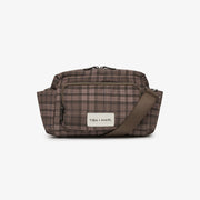 A brown and beige plaid crossbody bag with a brown strap and a white brand label reading 'TBA + MARI', shown against a plain white background.