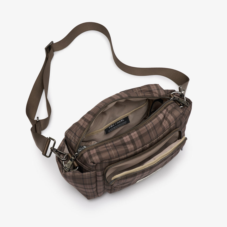 A brown plaid crossbody bag with an adjustable shoulder strap, shown open against a light gray background.