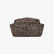 A leopard print toiletry bag with a brown and beige base and black spots, photographed against a solid white background.