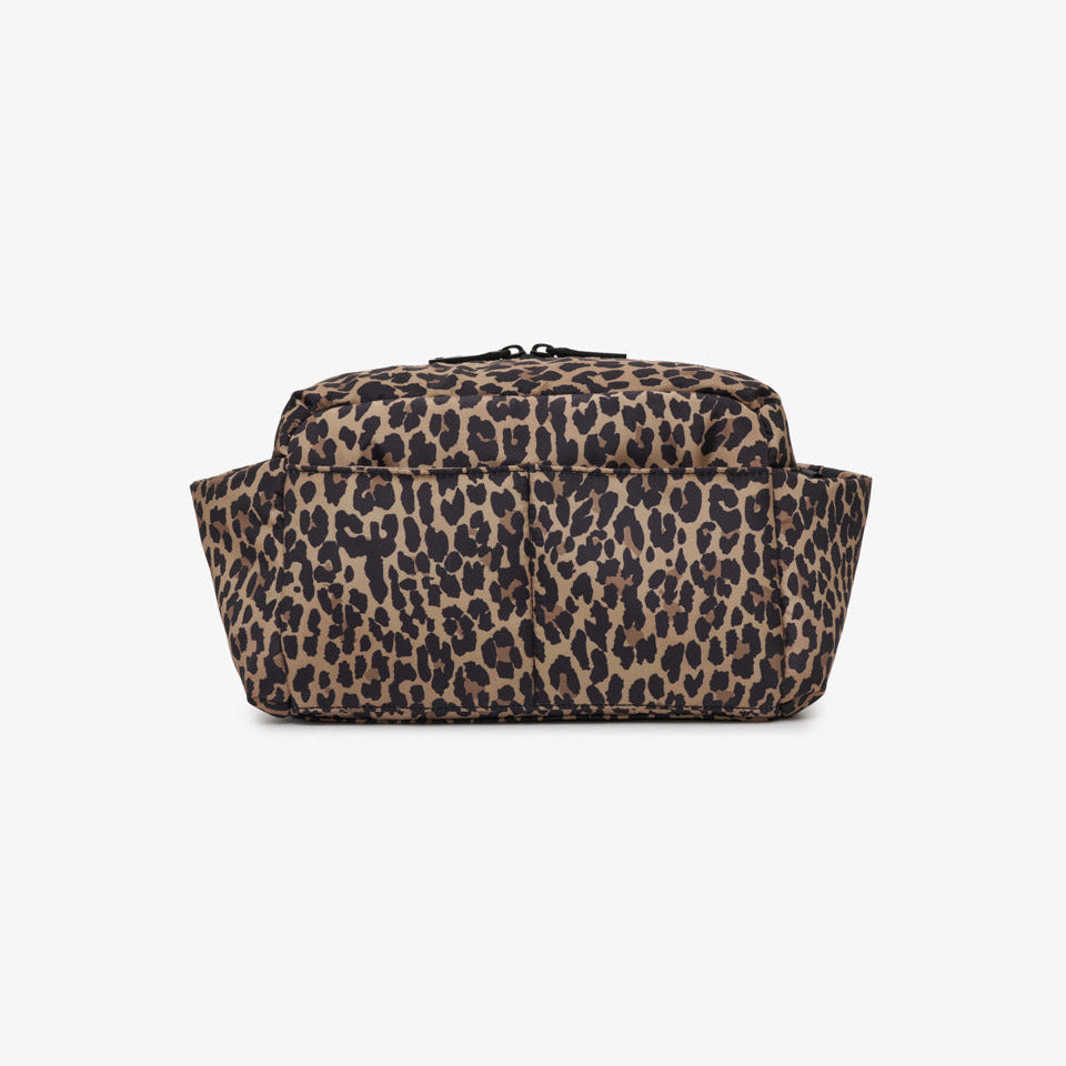 A leopard print toiletry bag with a brown and beige base and black spots, photographed against a solid white background.