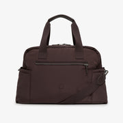 A dark brown nylon duffel bag with dual top handles, a front zippered pocket, and an adjustable shoulder strap, shown against a plain light gray background.