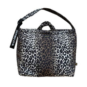 A leopard print tote bag with black handles and a black shoulder strap, featuring a black hanging tag with the brand name 'WILDRIDE'.