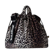 A leopard print drawstring bag with a black adjustable shoulder strap featuring the brand name 'WILDRIDE' in white text, shown against a plain white background.