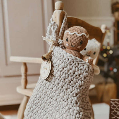 Crochet Christmas stocking with a knitted gingerbread man and knitted snowman inside