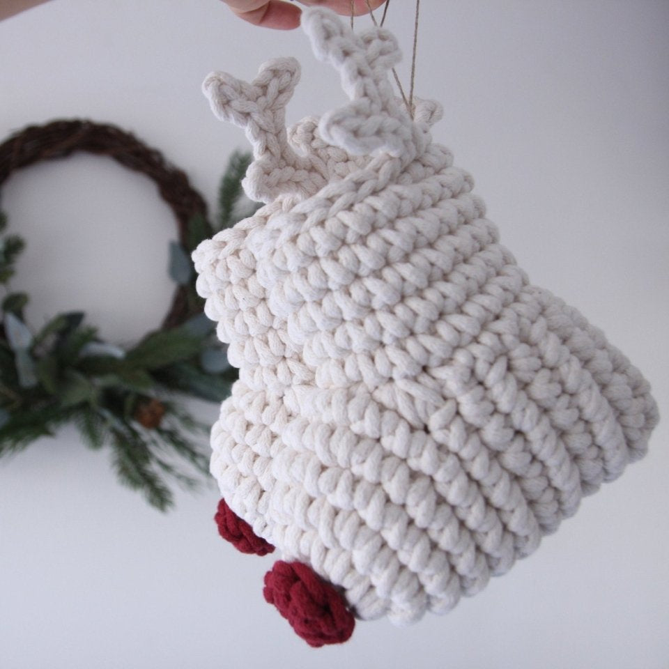 White crochet reindeer ornaments with red noses on a white background