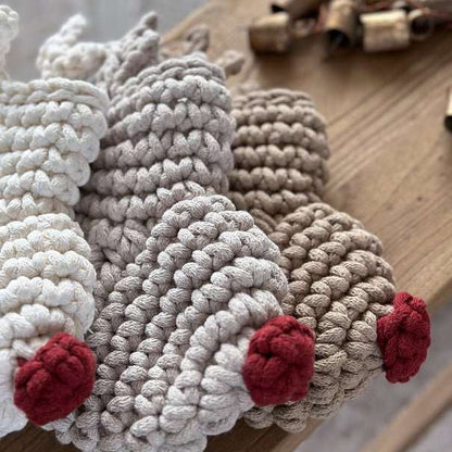 Crocheted reindeer Christmas stockings on a wooden surface
