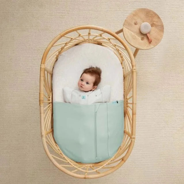 ergoPouch - Drift Away White Noise & Nightlight Machine next to baby crib