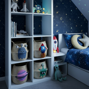 Children's room with space-themed decor, including a bookshelf with toys and a bed with star-patterned bedding.
