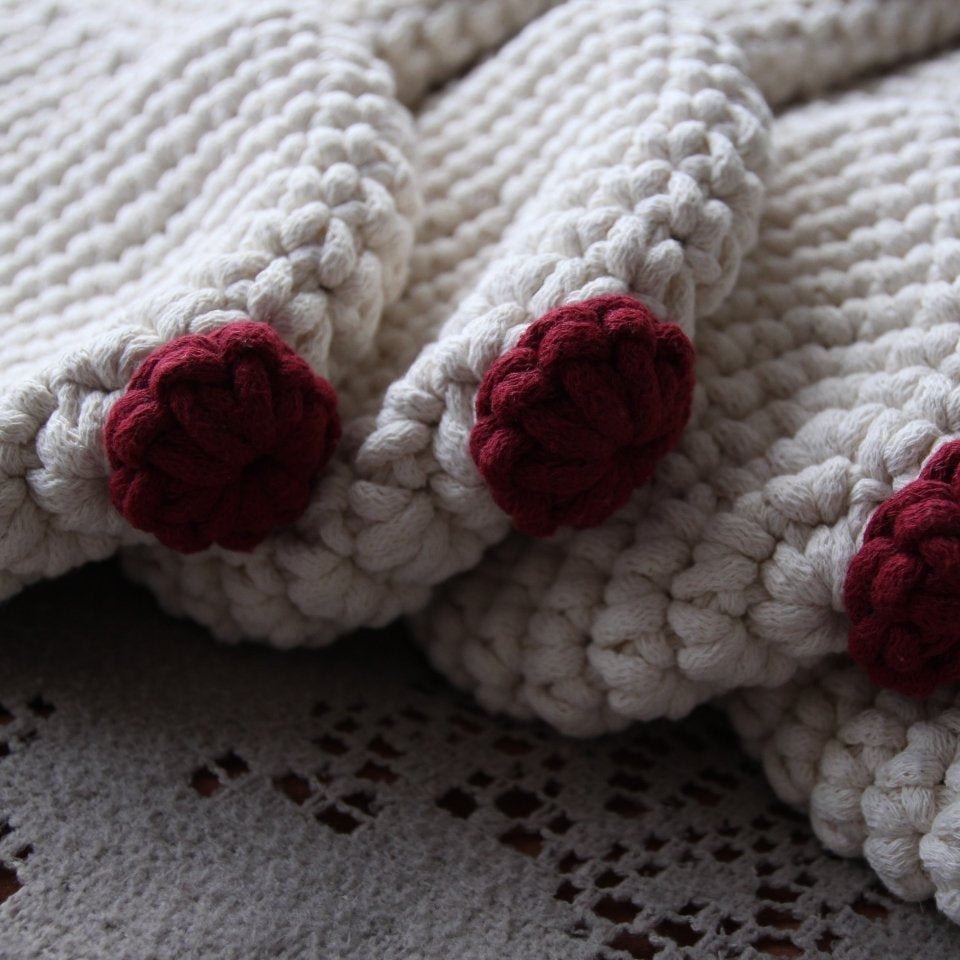 White crocheted Christmas stockings with red noses