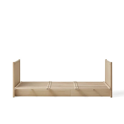A light natural wood bed frame with a slatted base and upright side rails, shown from the front on a plain white background.