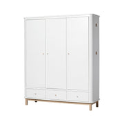White and oak Nordic-style triple wardrobe with flexible shelving, soft-close drawers, and integrated oak hooks for bedrooms and nurseries.