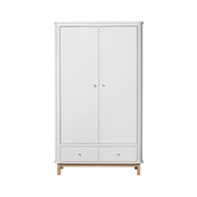 White and oak Nordic-style double wardrobe with two doors, flexible shelving, soft-close storage drawers, and integrated rounded hooks for modern nursery or bedroom organization.