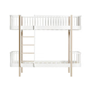 Oliver Furniture Wood Original white and oak bunk bed with left-side ladder and curved safety rails, designed for siblings and convertible into two separate beds.