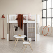 Oliver Furniture PingPong kids chair in white and oiled oak veneer, complementing a modern Scandinavian-style children's room with a loft bed, round table, and natural light. 